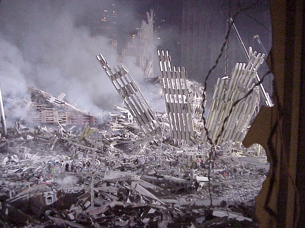 World Trade Center site in 2001: the collapsed facade of the tower standing amid debris and smoke.